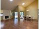 Open-concept dining area with hardwood floors, chandelier, and sliding glass doors to the patio at 7200 Green Pine Ct, Orlando, FL 32819