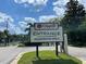 Community entrance sign reading 'Orange Tree, Residents Only' set against a backdrop of lush greenery and a clear blue sky at 7200 Green Pine Ct, Orlando, FL 32819