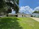 Charming single-story home with a well-manicured lawn and driveway leading to the attached garage at 7200 Green Pine Ct, Orlando, FL 32819