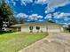 Charming single-story home featuring a well-manicured lawn and an attached two-car garage at 7200 Green Pine Ct, Orlando, FL 32819