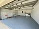 Clean, spacious garage with epoxy flooring, washer, dryer, and water heater at 7200 Green Pine Ct, Orlando, FL 32819