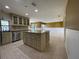 Spacious open kitchen featuring tile floors, recessed lights, a center island and stainless appliances at 7200 Green Pine Ct, Orlando, FL 32819
