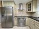Updated kitchen showcasing stainless appliances, granite countertops, and cream-colored cabinets at 7200 Green Pine Ct, Orlando, FL 32819
