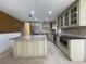 Well-lit kitchen with stainless appliances, granite countertops, and a center island at 7200 Green Pine Ct, Orlando, FL 32819