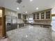 A modern kitchen features granite countertops, stainless steel appliances, and custom cabinets with glass inserts at 7200 Green Pine Ct, Orlando, FL 32819