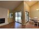 Bright living room features hardwood floors, sliding glass doors to the backyard, and a brick fireplace at 7200 Green Pine Ct, Orlando, FL 32819