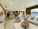 Open-concept living space connects a kitchen with granite island to a dining area and sitting room at 7200 Green Pine Ct, Orlando, FL 32819
