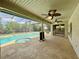 Outdoor patio with a covered ceiling, screened-in windows, ceiling fans, a swimming pool, and a hot tub at 7200 Green Pine Ct, Orlando, FL 32819