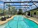 A spacious pool and hot tub are enclosed in a screen, with outdoor seating perfect for entertaining at 7200 Green Pine Ct, Orlando, FL 32819