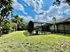 A beautiful screened-in pool is surrounded by a lush green lawn and tropical landscaping, perfect for outdoor relaxation at 7200 Green Pine Ct, Orlando, FL 32819