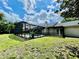 Large screened-in pool with lush landscaping creating a private backyard oasis at 7200 Green Pine Ct, Orlando, FL 32819