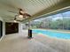 A covered and screened lanai area featuring ceiling fans, an outdoor pool, and a connected jacuzzi at 7200 Green Pine Ct, Orlando, FL 32819