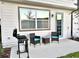 Outdoor seating area with a grill, chairs, and a small table on a concrete patio at 726 Longboat, Davenport, FL 33896