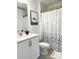 Bathroom with white vanity, toilet, bathtub with shower, and decorated with Disney themes at 726 Longboat, Davenport, FL 33896