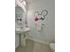 Charming bathroom with Mickey Mouse decor and a pedestal sink at 726 Longboat, Davenport, FL 33896