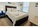 Bedroom featuring a dark wood bed frame with striped linens, blue lamps, and light colored walls at 726 Longboat, Davenport, FL 33896