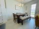 Bright dining room with modern chandelier and access to backyard at 726 Longboat, Davenport, FL 33896