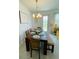 Bright dining room with modern chandelier and backyard access at 726 Longboat, Davenport, FL 33896