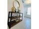 Hallway console table with rustic wood shelves, metal frame, and decorative accents at 726 Longboat, Davenport, FL 33896