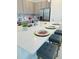 Bright kitchen featuring a quartz countertop island with bar stool seating and stainless steel appliances at 726 Longboat, Davenport, FL 33896