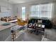 Bright living room with modern furnishings, large windows, and an open floor plan leading to the dining area at 726 Longboat, Davenport, FL 33896