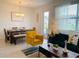 Open concept living room and dining area with modern decor and backyard access at 726 Longboat, Davenport, FL 33896