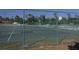 Fenced outdoor basketball court in a community with basketball hoops, painted lines, and trees in background at 726 Marion Oaks Ln, Ocala, FL 34473