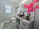 Bathroom featuring gray vanity, bowl sink, modern finishes, and stylish decor, offering a fresh and appealing space at 726 Marion Oaks Ln, Ocala, FL 34473