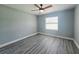 Bedroom featuring wood-look flooring, a ceiling fan, and a bright window, creating a comfortable and inviting atmosphere at 726 Marion Oaks Ln, Ocala, FL 34473