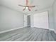 Bedroom featuring wood-look flooring, ceiling fan, and ample closet space, creating a comfortable and functional living area at 726 Marion Oaks Ln, Ocala, FL 34473