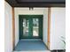 A close up of the green double door entry with wooden beam accents at 726 Marion Oaks Ln, Ocala, FL 34473