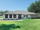 Charming single-story home boasts a well-manicured lawn and modern black-framed windows at 726 Marion Oaks Ln, Ocala, FL 34473