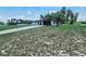 Home showcasing a spacious front yard with a long driveway and palm trees at 726 Marion Oaks Ln, Ocala, FL 34473