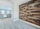 Hallway featuring unique wooden accent wall and an adjacent open kitchen with stainless steel appliances at 726 Marion Oaks Ln, Ocala, FL 34473