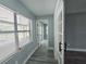 Hallway with updated flooring and fresh paint and an open doorway to a bedroom in the distance at 726 Marion Oaks Ln, Ocala, FL 34473