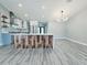 Stylish kitchen with a wooden accent island, marble backsplash, stainless steel appliances and vaulted ceiling at 726 Marion Oaks Ln, Ocala, FL 34473