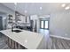 Kitchen island with white countertop and wooden accents, stainless appliances, marble backsplash, and gray cabinets at 726 Marion Oaks Ln, Ocala, FL 34473