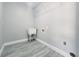 Laundry room featuring sleek flooring, utility sink, and wire shelving, combining convenience with practical storage solutions at 726 Marion Oaks Ln, Ocala, FL 34473