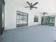 Screened patio with ceiling fans overlooking a pool, creating a relaxing outdoor space for leisure and entertainment at 726 Marion Oaks Ln, Ocala, FL 34473
