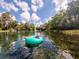 Enjoying a relaxing float on a tranquil river surrounded by lush greenery under a sunny sky at 726 Marion Oaks Ln, Ocala, FL 34473
