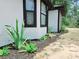 Side view of a house with modern landscaping including green plants and mulch at 726 Marion Oaks Ln, Ocala, FL 34473