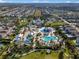 Aerial view showcasing a large community waterpark, residential buildings, and green spaces in a planned neighborhood at 7527 Marker Ave, Kissimmee, FL 34747
