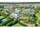 Aerial view of a community waterpark featuring vibrant slides, pools, and lush greenery providing recreational amenities at 7527 Marker Ave, Kissimmee, FL 34747
