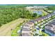 Suburban aerial shows homes backing to a lush wooded area, serene atmosphere with community access and picturesque landscaping at 7527 Marker Ave, Kissimmee, FL 34747