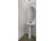 Contemporary powder room with pedestal sink and modern fixtures at 7527 Marker Ave, Kissimmee, FL 34747