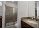 Bright bathroom showcases a granite vanity and a glass-enclosed shower with tiled walls at 7527 Marker Ave, Kissimmee, FL 34747