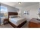 Bedroom featuring a large bed with decorative pillows, wood furniture and carpeted floors at 7527 Marker Ave, Kissimmee, FL 34747