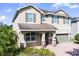 Charming two-story home with neutral-colored exterior and brick-paved driveway at 7527 Marker Ave, Kissimmee, FL 34747