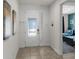Inviting foyer with tile flooring, leading to a view of a bedroom with blue decor at 7527 Marker Ave, Kissimmee, FL 34747