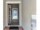 A close-up of a front door with sidelight and decorative glass, plus stone accents at 7527 Marker Ave, Kissimmee, FL 34747
